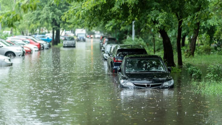 Flooded cars on the street of the city. Street after heavy rain.