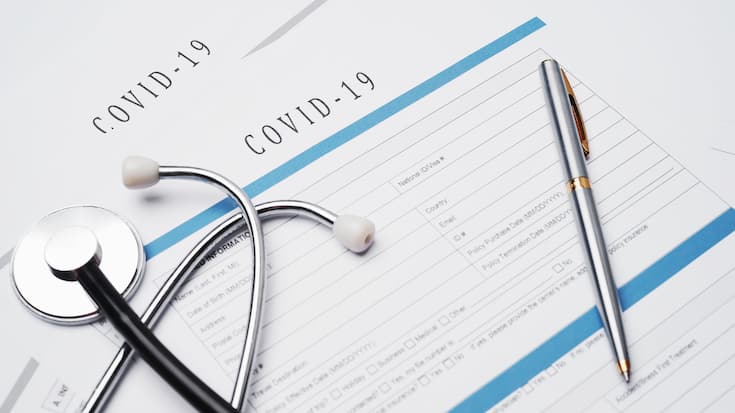 Coronavirus or COVID19  insurance policy document on desk, Health Care Insurance Plan concept.