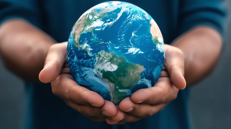 Close-up of hands holding a globe, symbolizing global unity in climate advocacy efforts