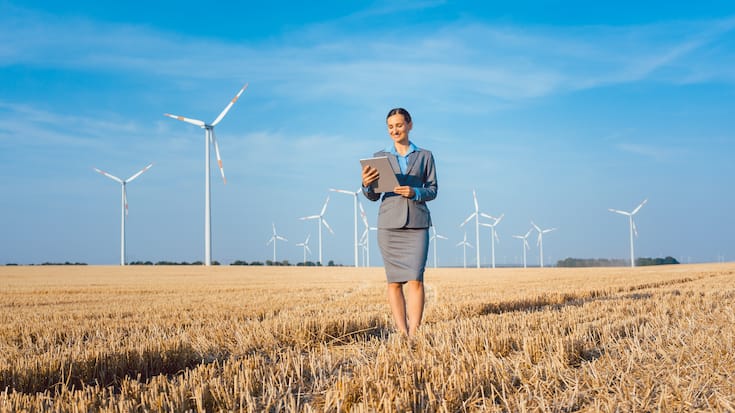 Women putting money into an ethical Investment of wind turbines
