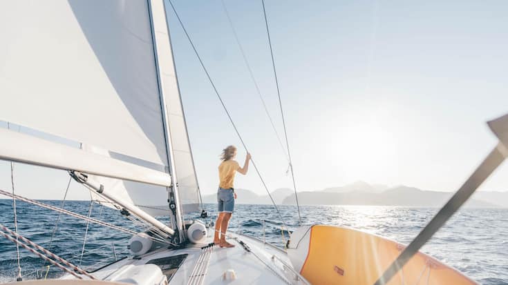 Caucasian man standing on yacht deck.