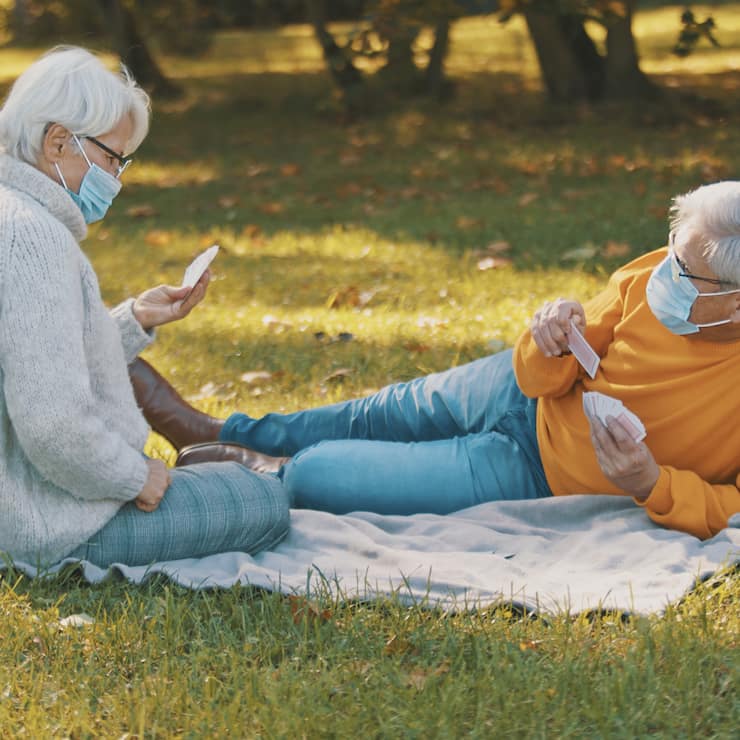 Anniversary celebration in the park during covid-19. Elderly cou