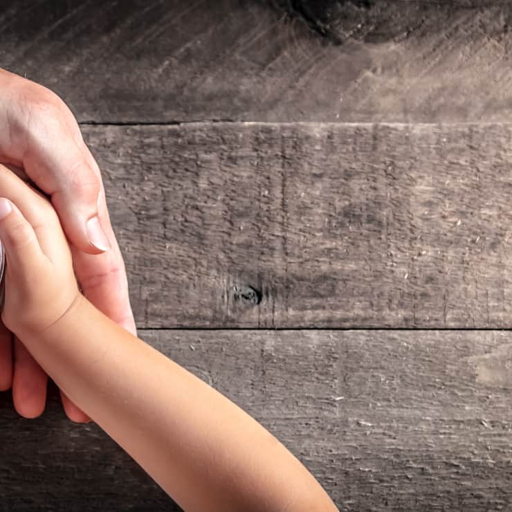 Hands Of Father Giving Jar Of Coins To Child On Wooden Table Background - Inheritance / Parent Providing For Children Concept