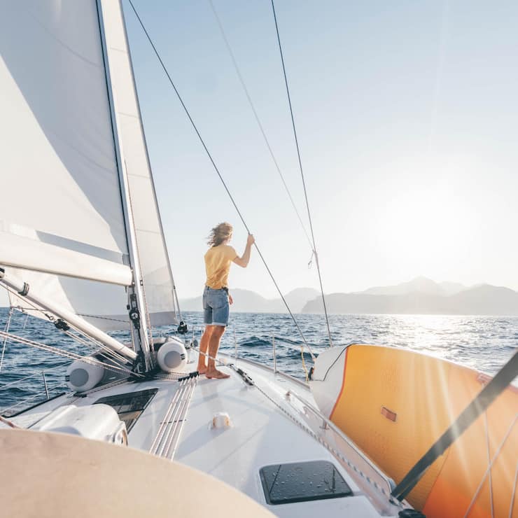 Caucasian man standing on yacht deck.